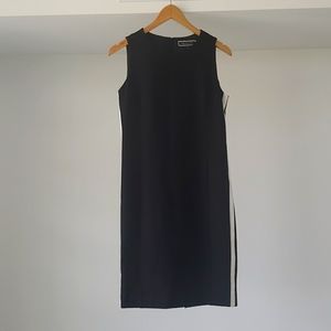 Melanie Lyne black dress with white stripe on sides.